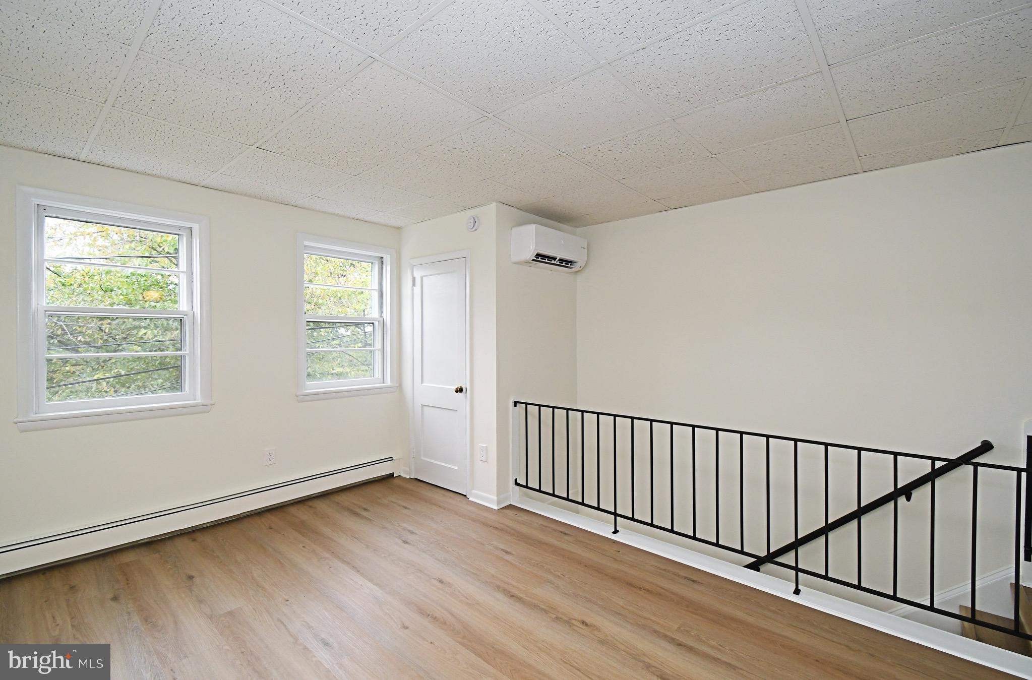 4776 Old Easton Road, Unit 2 Doylestown, PA 18902 - Photo 4 of 25 a view of a hallway with wooden floor and windows