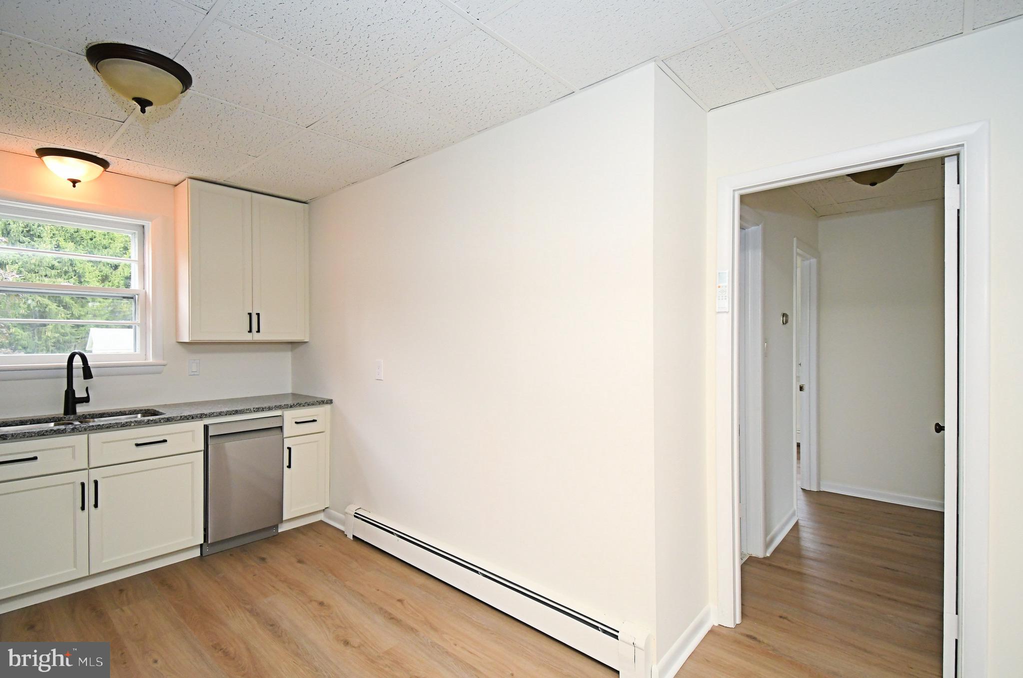 4776 Old Easton Road, Unit 2 Doylestown, PA 18902 - Photo 7 of 25 a kitchen with a sink cabinets stainless steel appliances and a window