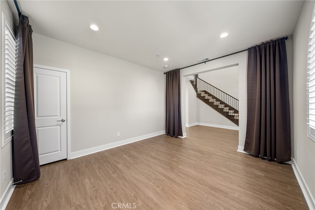 25110 Cherry Ridge Drive Canyon Country, CA 91387 - Photo 11 of 74 a view of an empty room with wooden floor and stairs