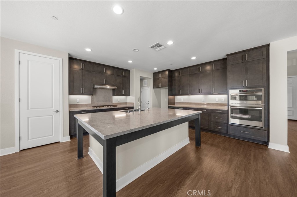 25110 Cherry Ridge Drive Canyon Country, CA 91387 - Photo 21 of 74 a kitchen with stainless steel appliances granite countertop a sink a microwave a refrigerator and a stove