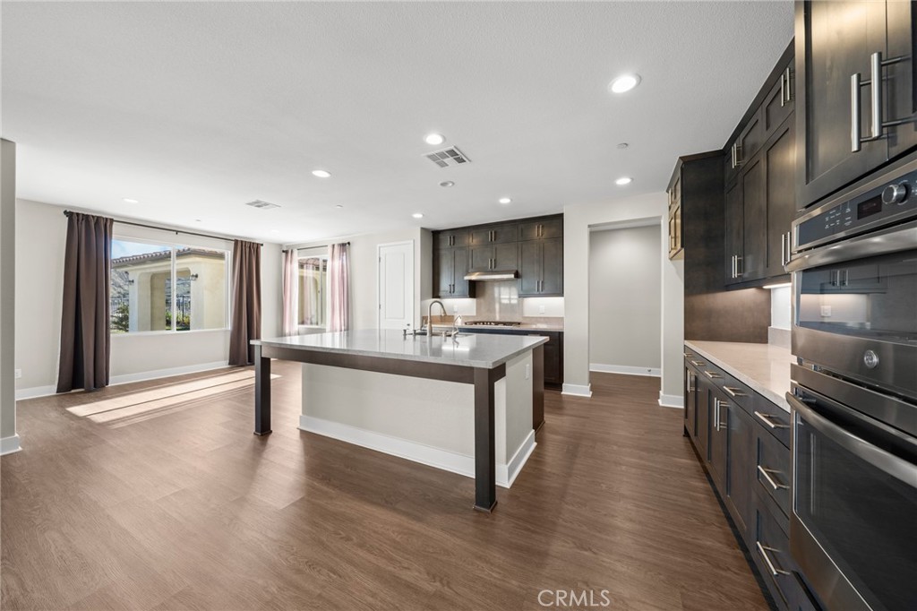 25110 Cherry Ridge Drive Canyon Country, CA 91387 - Photo 25 of 74 a large kitchen with stainless steel appliances granite countertop a lot of counter space and wooden floor