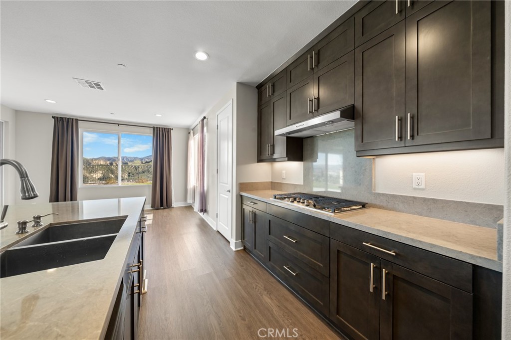 25110 Cherry Ridge Drive Canyon Country, CA 91387 - Photo 26 of 74 a kitchen with stainless steel appliances granite countertop a sink stove and refrigerator