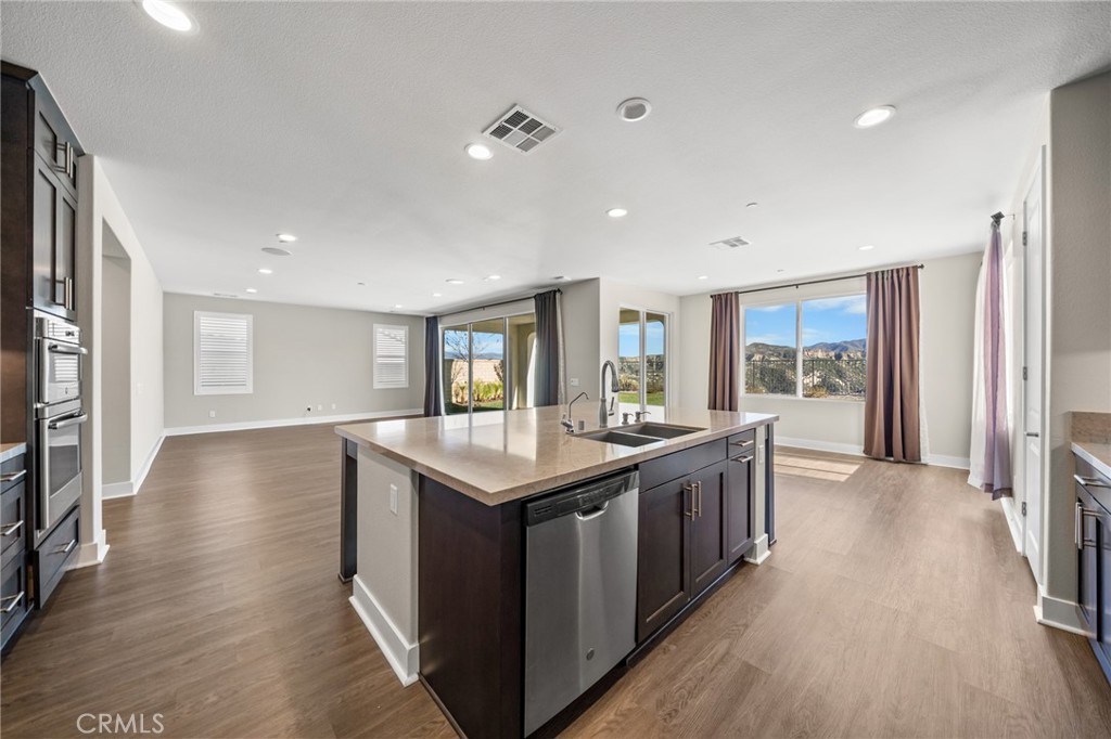 25110 Cherry Ridge Drive Canyon Country, CA 91387 - Photo 27 of 74 a kitchen with stainless steel appliances granite countertop a stove and a refrigerator