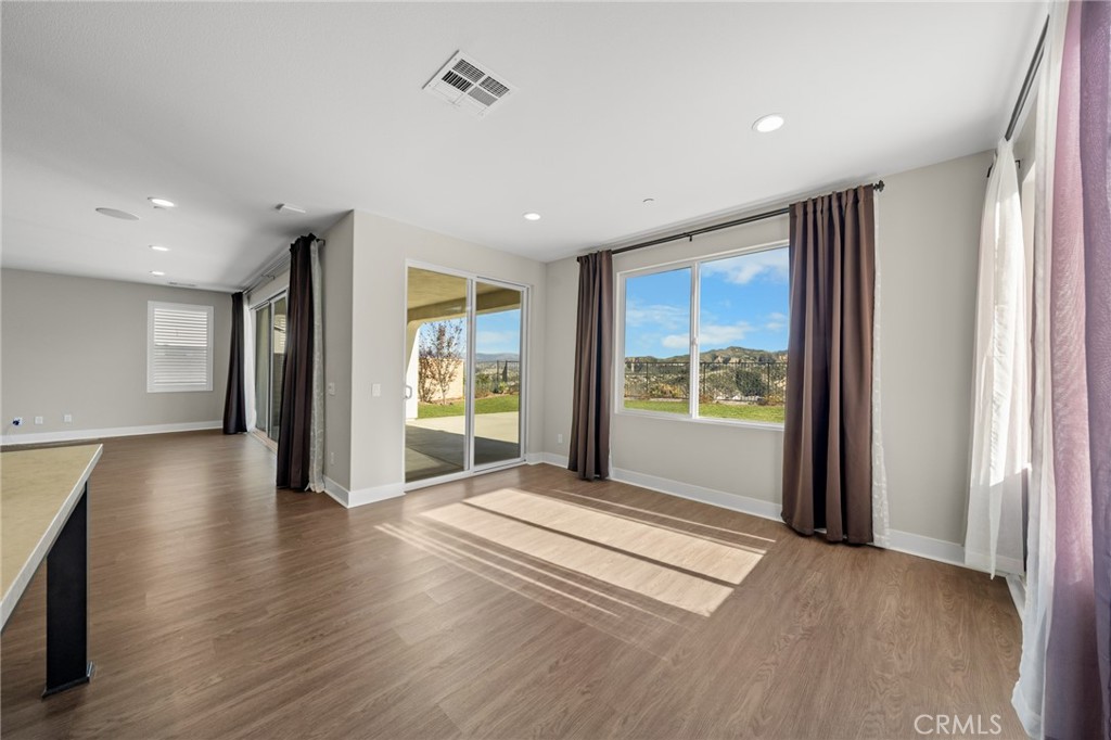25110 Cherry Ridge Drive Canyon Country, CA 91387 - Photo 29 of 74 a view of an empty room with wooden floor and a window