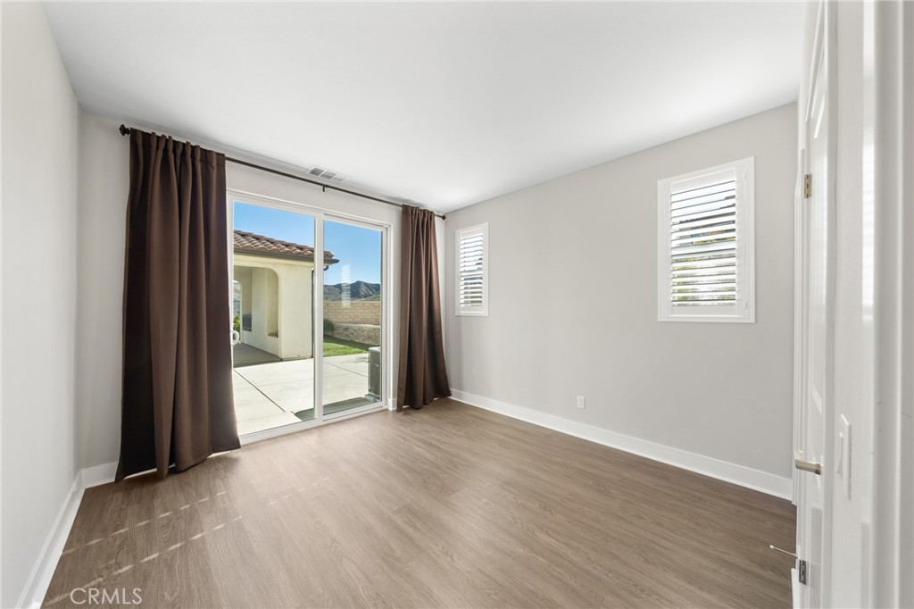 25110 Cherry Ridge Drive Canyon Country, CA 91387 - Photo 33 of 74 a view of an empty room with wooden floor and a window