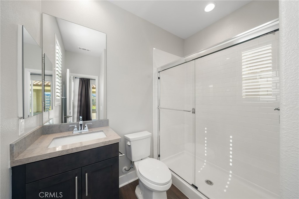 25110 Cherry Ridge Drive Canyon Country, CA 91387 - Photo 35 of 74 a bathroom with a granite countertop sink toilet and shower