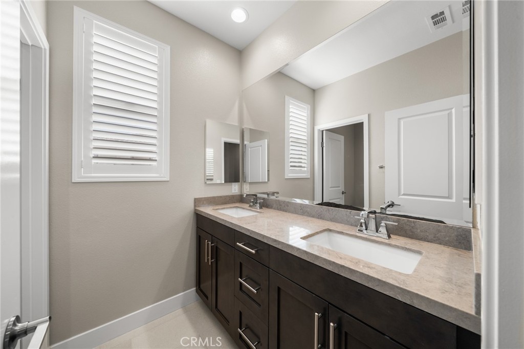 25110 Cherry Ridge Drive Canyon Country, CA 91387 - Photo 59 of 74 a bathroom with a sink double vanity and a mirror