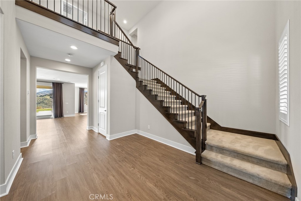 25110 Cherry Ridge Drive Canyon Country, CA 91387 - Photo 7 of 74 a view of a hallway with wooden floor and staircase