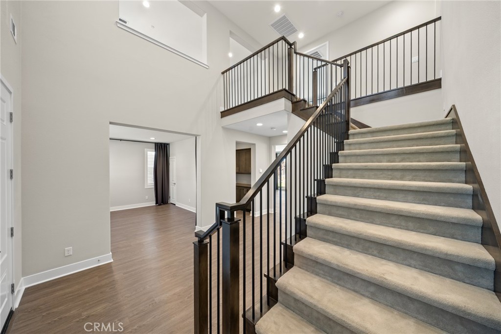 25110 Cherry Ridge Drive Canyon Country, CA 91387 - Photo 8 of 74 a view of staircase with wooden floor and a rug