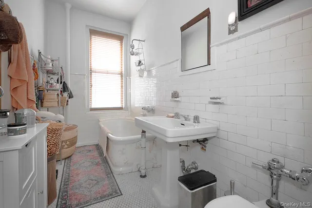 a bathroom with a sink a toilet and a bathtub
