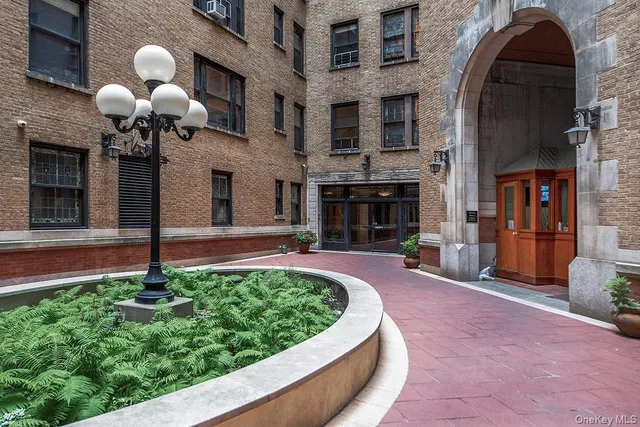 a front view of a house with a yard fire pit and chairs