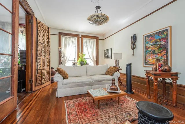 a living room with fireplace furniture and a large window