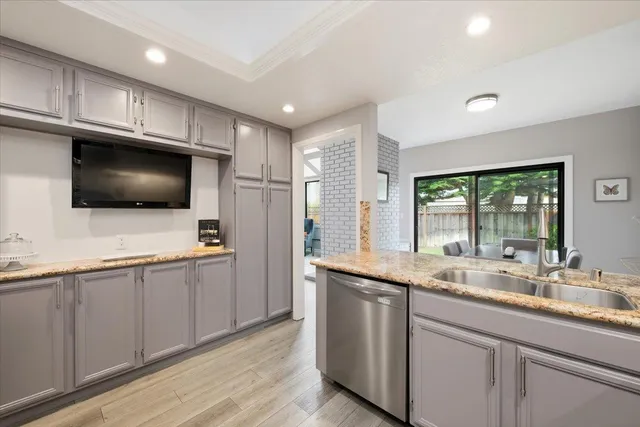 a kitchen with stainless steel appliances a stove microwave and sink