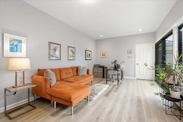 a living room with furniture and a lamp