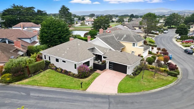 an aerial view of a house with a garden and trees