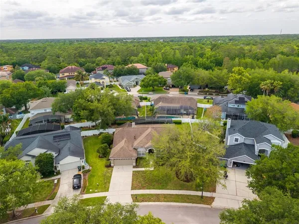 an aerial view of a house with garden space and street view