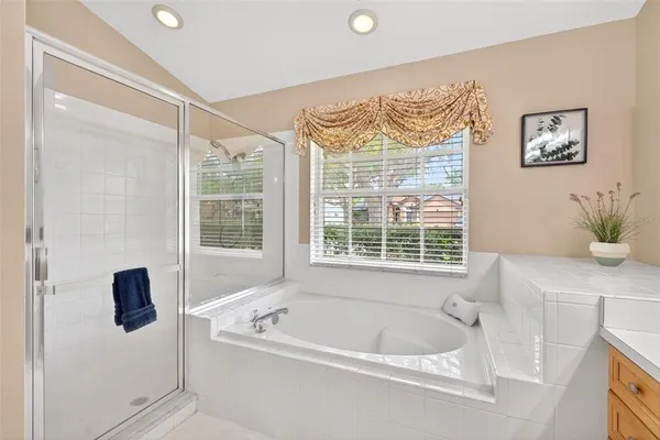 a bedroom with a bed and painting on the wall
