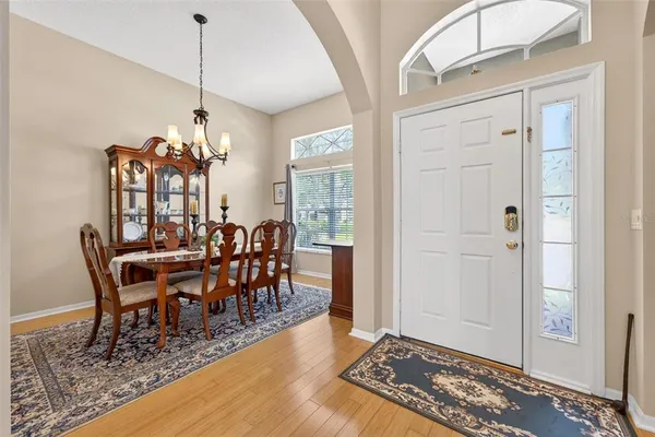 a view of a dining room with furniture and chandelier