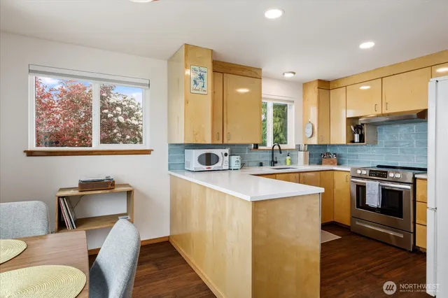 a kitchen with stainless steel appliances granite countertop a sink and a stove