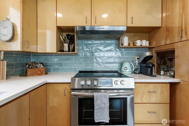 a kitchen with stainless steel appliances granite countertop a stove and a sink