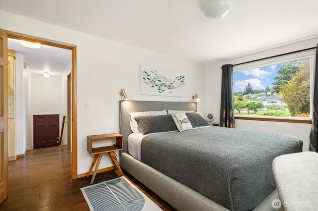 a bedroom with a bed and a painting on the wall