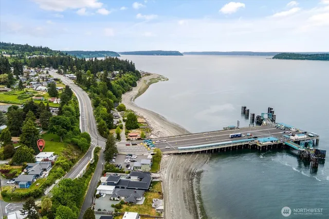 a view of a lake with boats and trees in the background