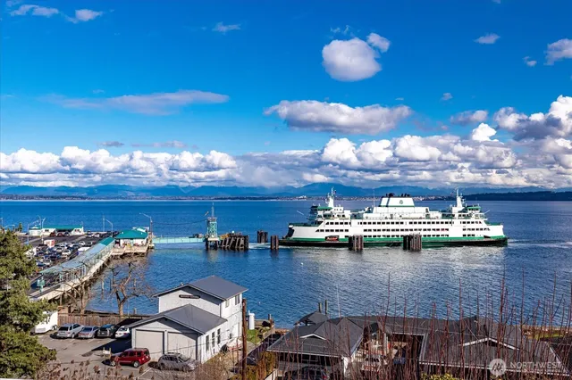 a view of a lake with lawn chairs