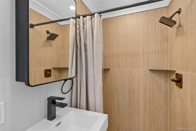 a bathroom with a sink a toilet and mirror