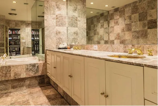 a bathroom with a granite countertop sink and a mirror