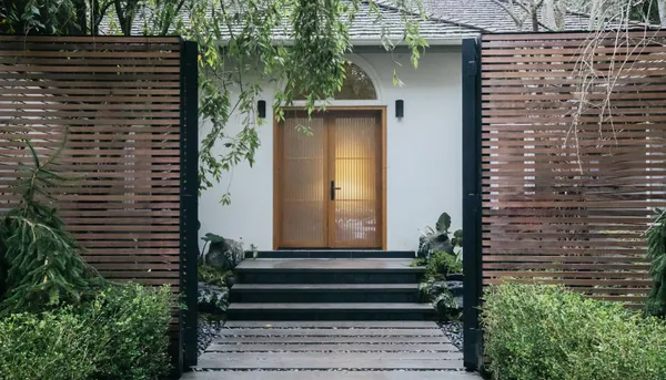 a front view of a house with a garden