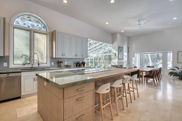 a kitchen with lots of counter top space and dining table