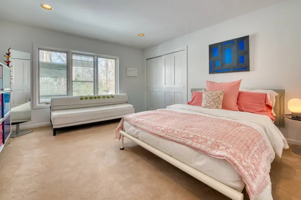a spacious bedroom with a bed and a couch