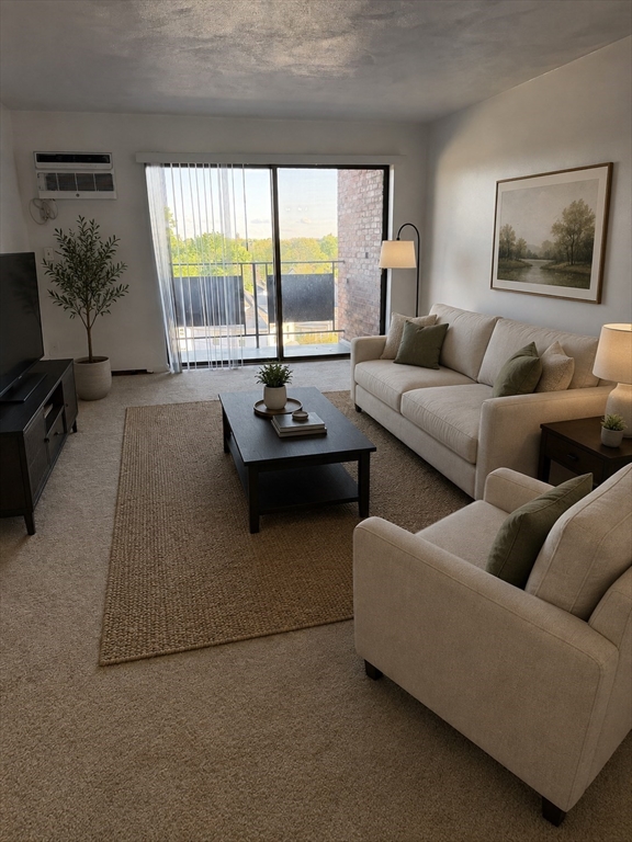 2 Victory Road, Unit 38 Lynn, MA 01902 - Photo 2 of 10 a living room with furniture and large windows