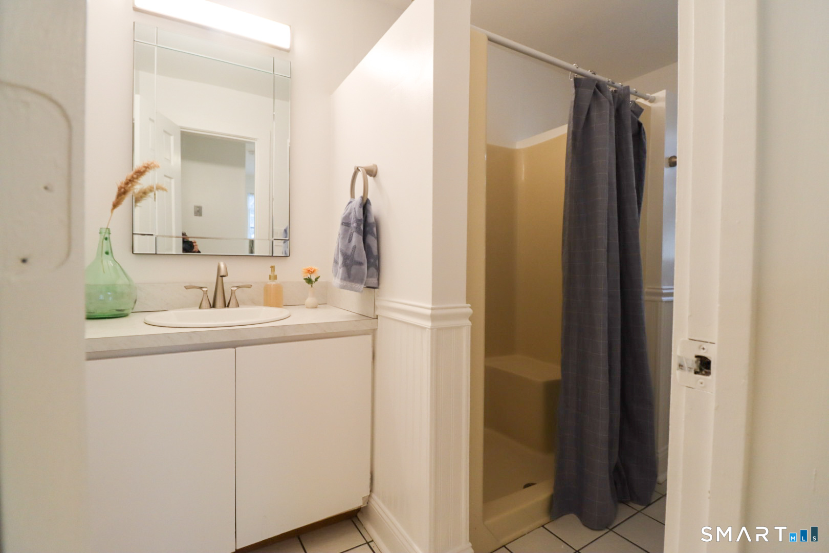 51 Franklin Street New London, CT 06320 - Photo 9 of 12 a bathroom with a sink and mirror