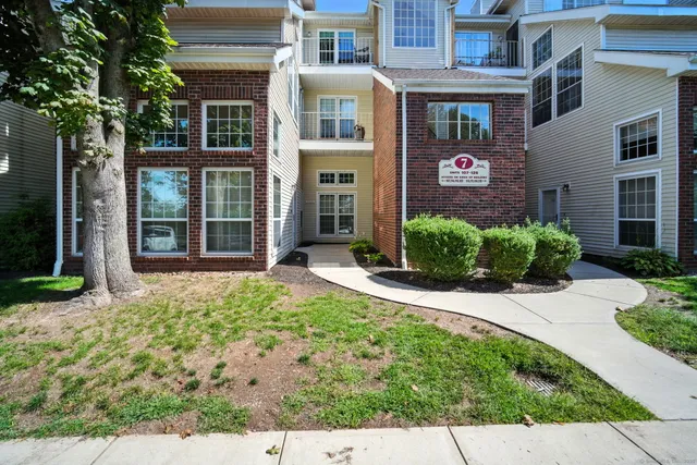 front view of a brick house with a small yard