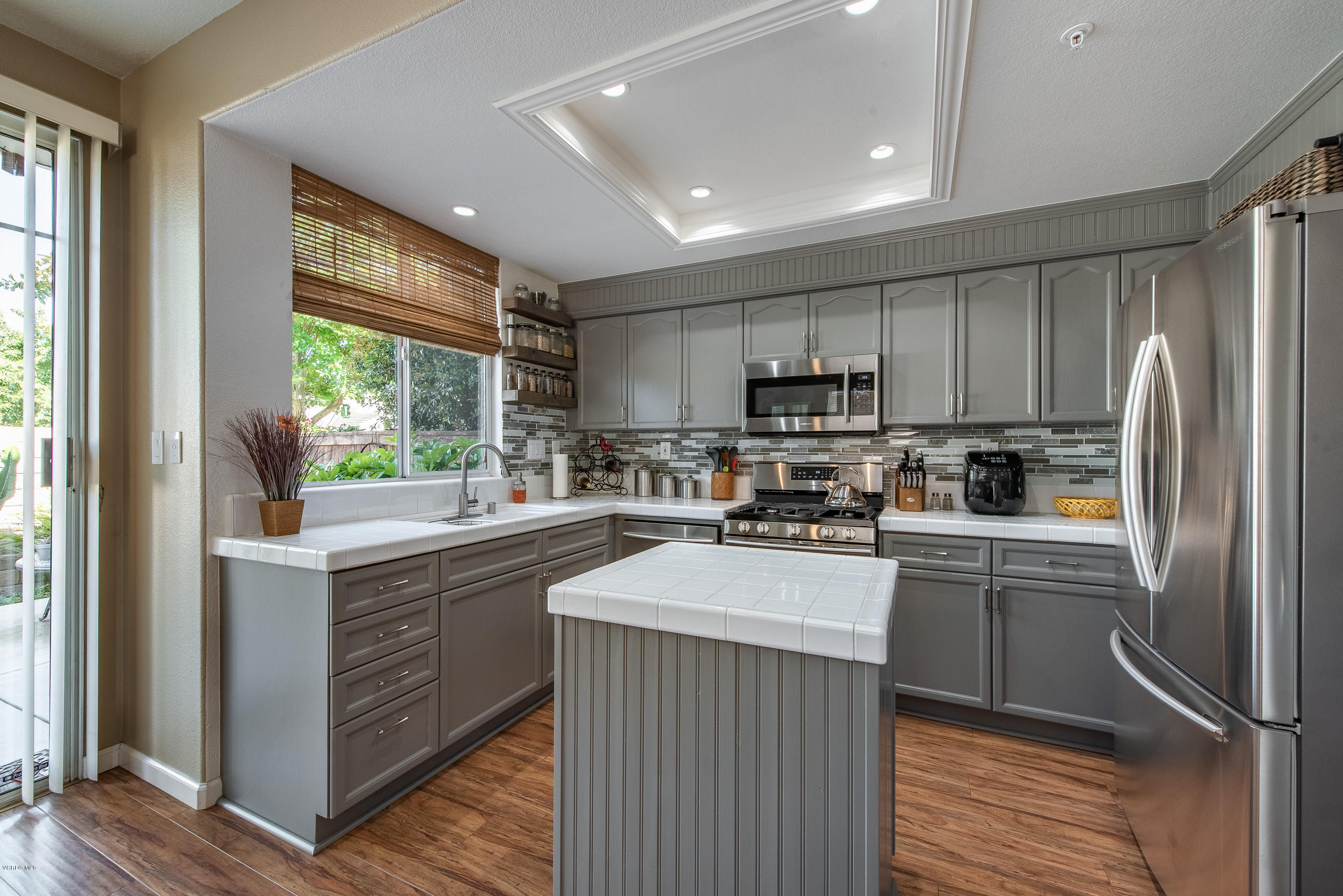 2050 Avila Place Oxnard, CA 93036 - Photo 12 of 31 a kitchen with stainless steel appliances granite countertop a refrigerator a sink dishwasher a stove and white countertops with wooden floor
