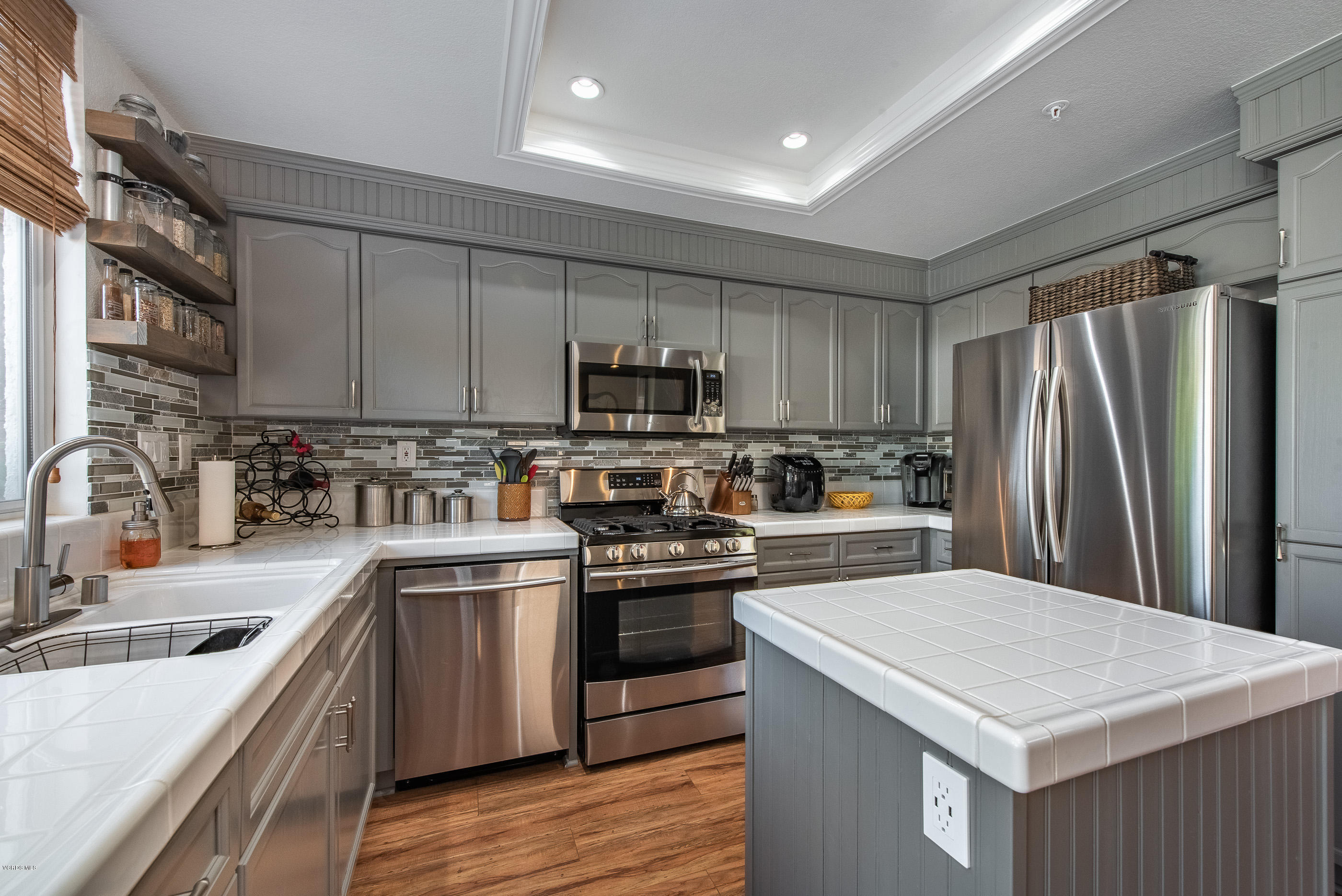 2050 Avila Place Oxnard, CA 93036 - Photo 13 of 31 a kitchen with a sink a stove a refrigerator and cabinets