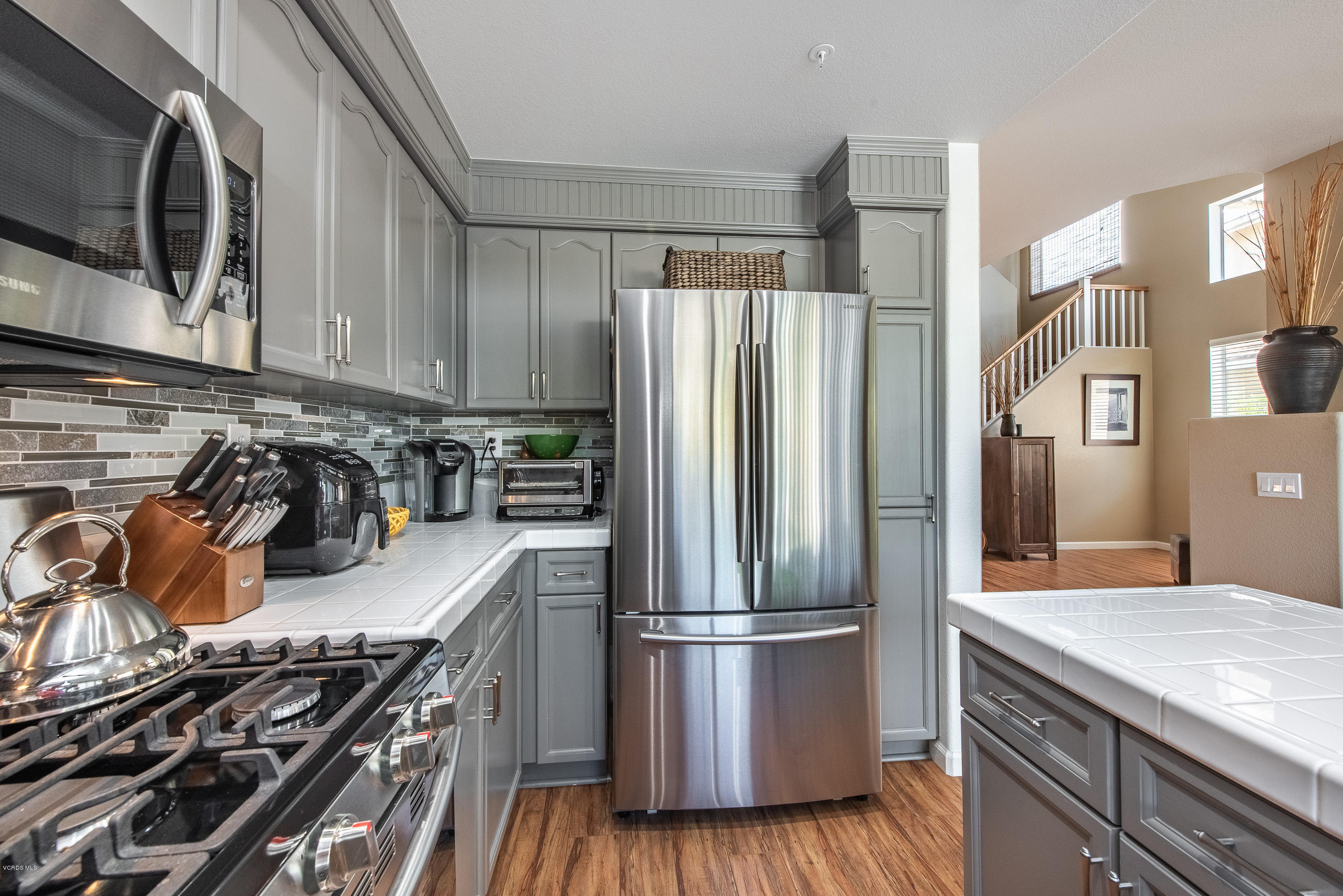 2050 Avila Place Oxnard, CA 93036 - Photo 15 of 31 a kitchen with stainless steel appliances granite countertop a refrigerator a stove and a sink with wooden floor