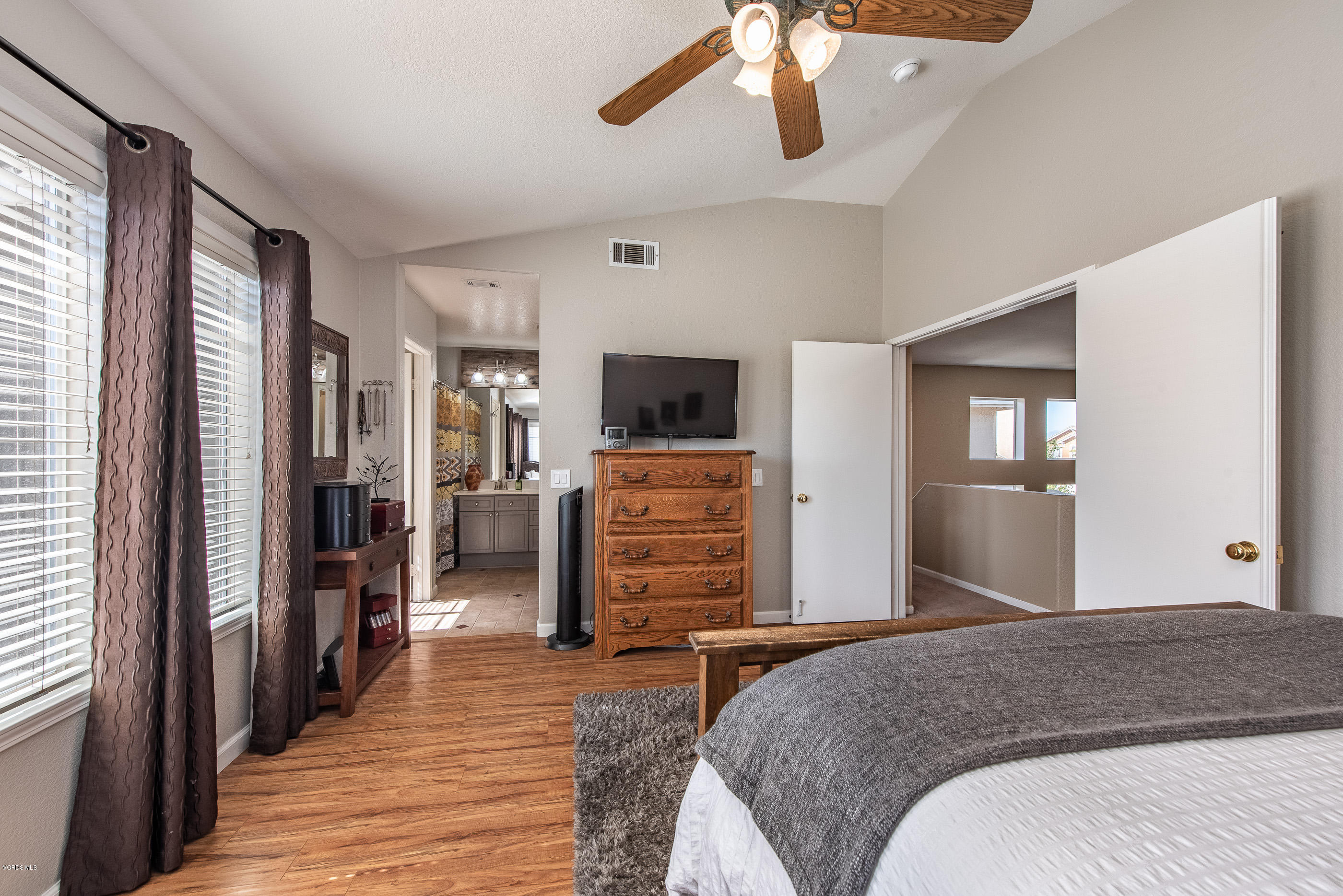 2050 Avila Place Oxnard, CA 93036 - Photo 19 of 31 a bedroom with a bed and wooden floor