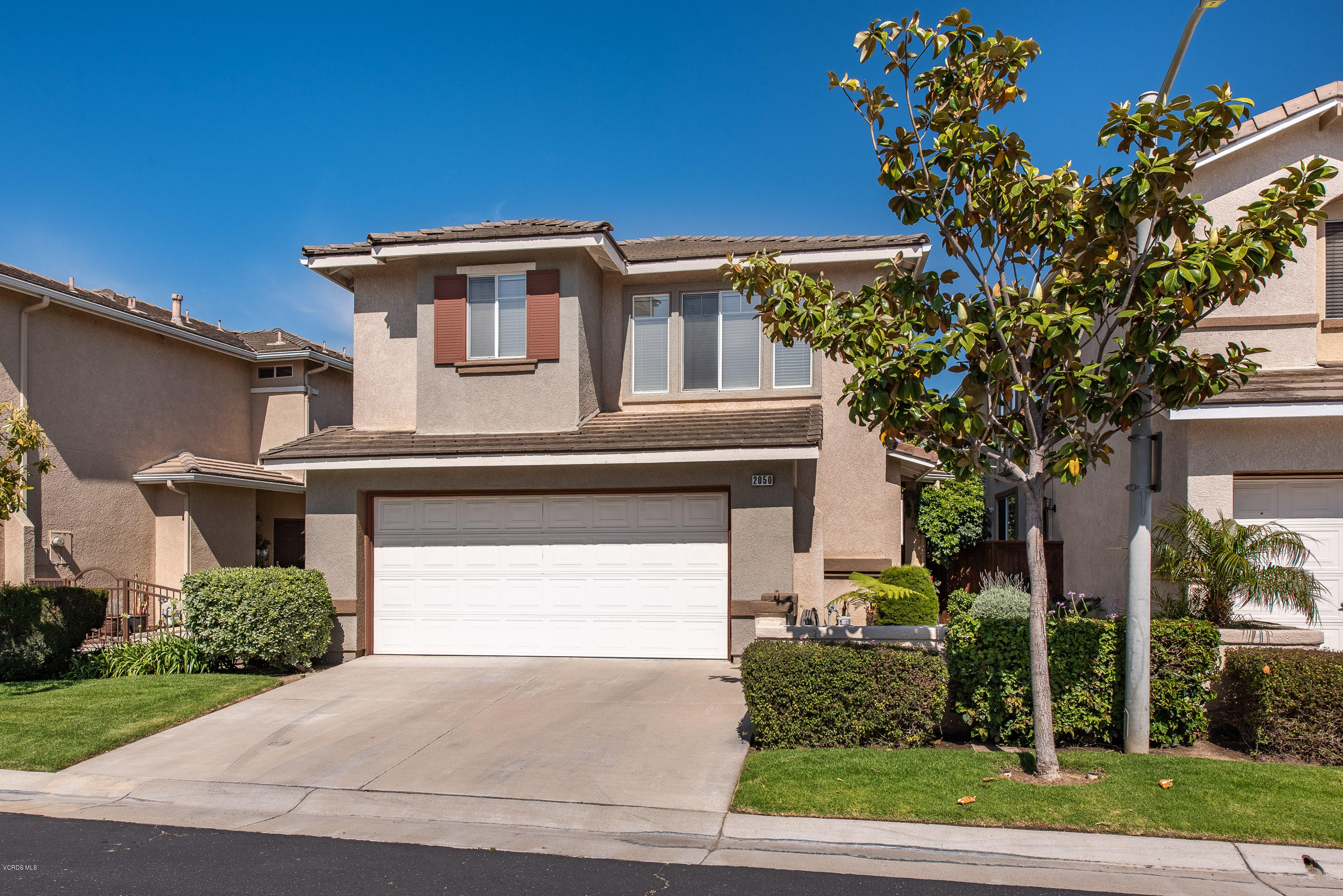 2050 Avila Place Oxnard, CA 93036 - Photo 3 of 31 a front view of a house with a yard