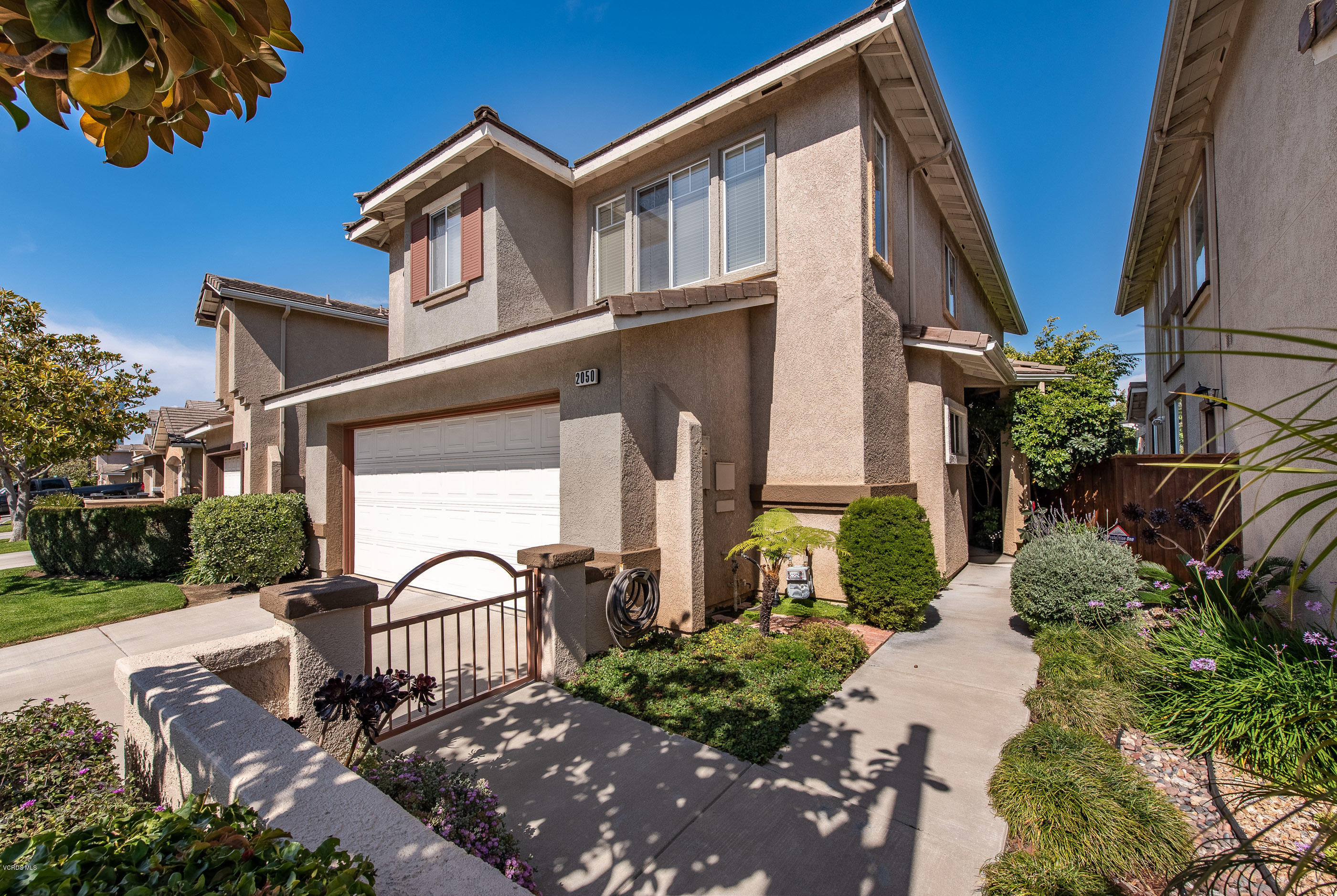 2050 Avila Place Oxnard, CA 93036 - Photo 4 of 31 a front view of a house with garden