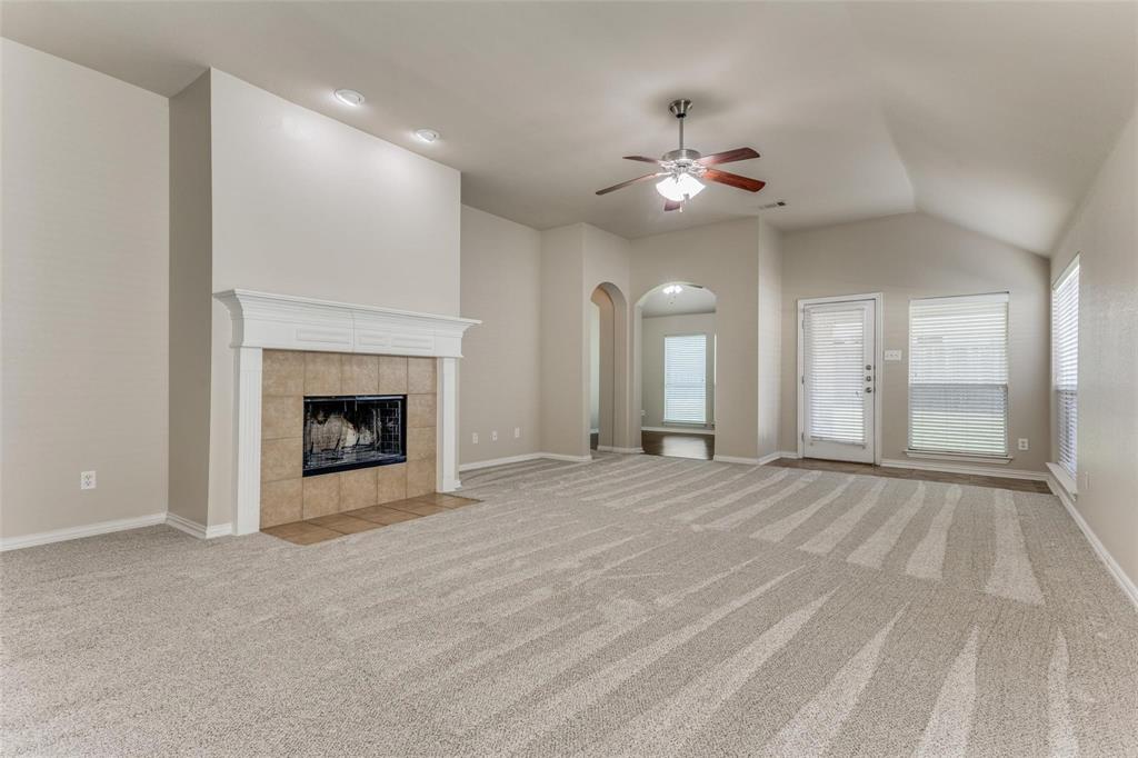 5304 Ridgepass Lane McKinney, TX 75071 - Photo 3 of 10 a view of an empty room with chandelier fan and fire place
