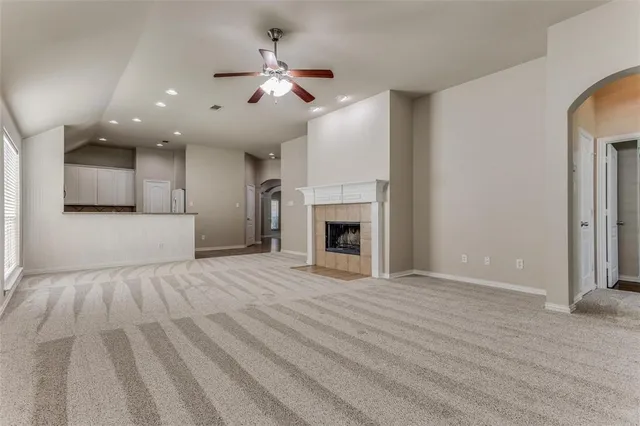 a view of an empty room with a fireplace