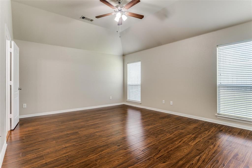 5304 Ridgepass Lane McKinney, TX 75071 - Photo 6 of 10 a view of an empty room with wooden floor and a window