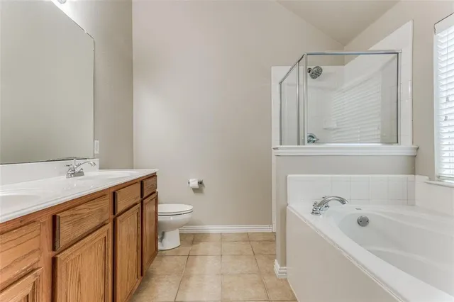 a bathroom with a tub sink toilet and mirror