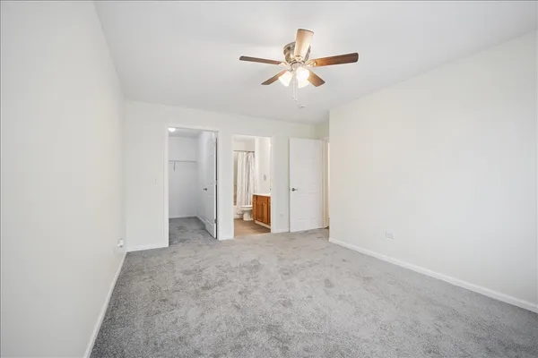 an empty room with closet and windows