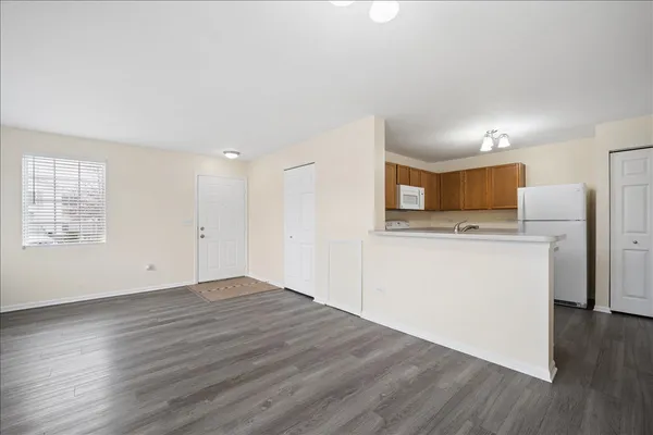 a view of cabinets with wooden floor and electronic appliances