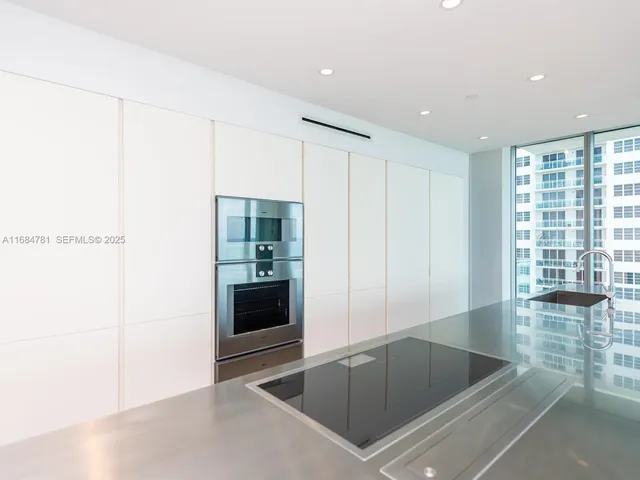 a floor to ceiling window and a balcony