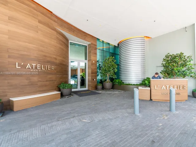 a view of a house with a patio and a yard
