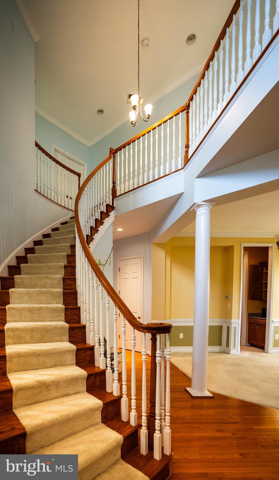 9571 Linnett Hill Drive Lorton, VA 22079 - Photo 3 of 27 a view of staircase with lots of frames on wall and wooden floor